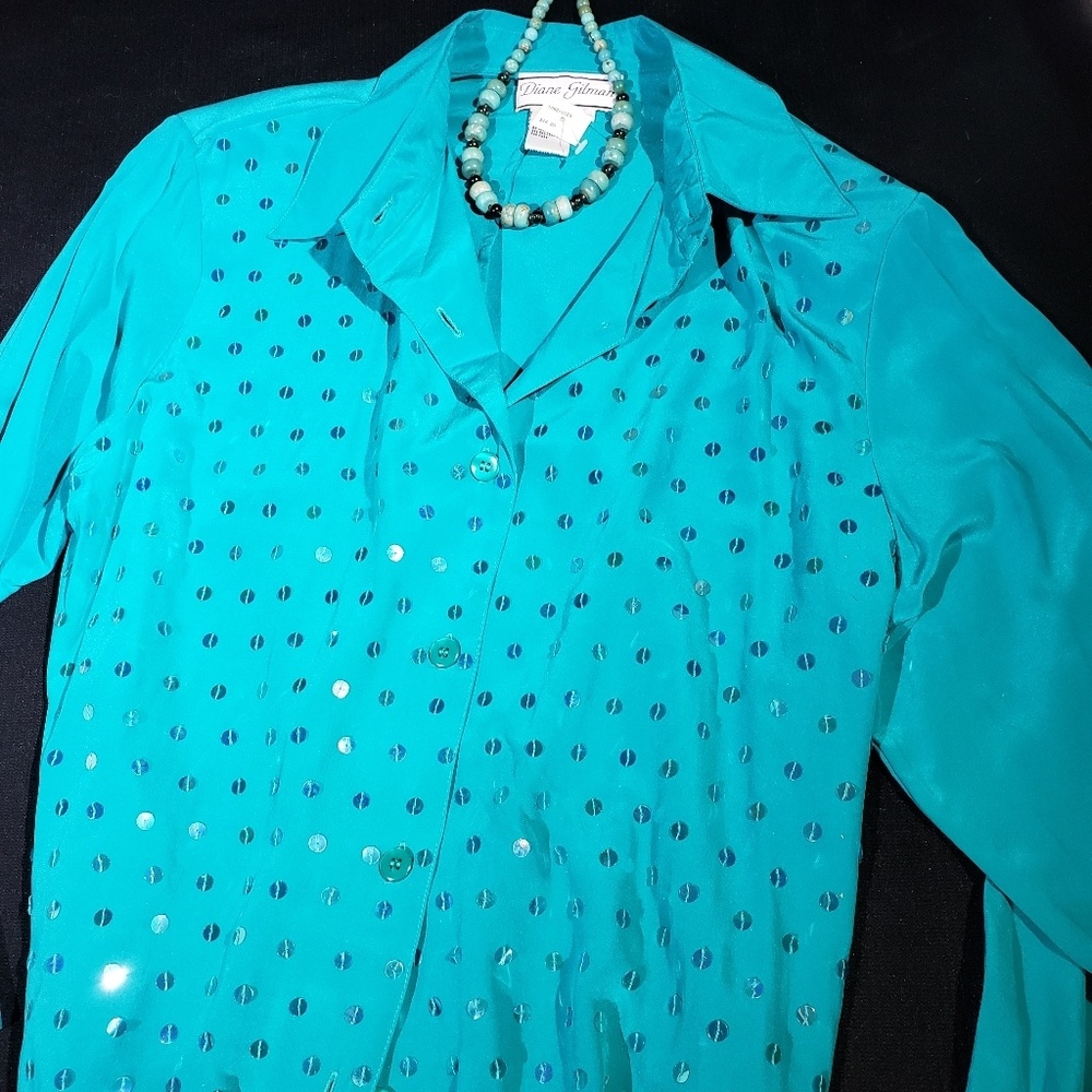 100% silk shirt with iridescent sequins sewn on it